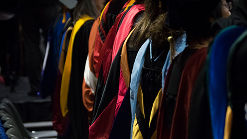 Image of faculty wearing commencement regalia.