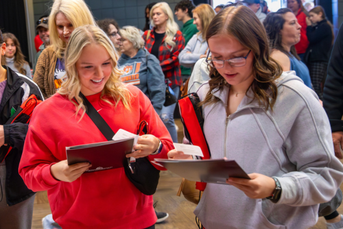 Students look through their first packet of SEMO information.