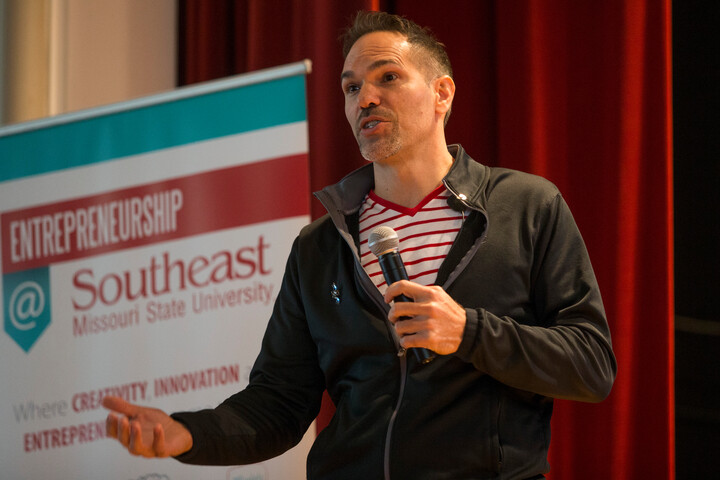A man speaks into a microphone at an entrepreneurial event at SEMO.