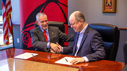 Southeast President Dr. Carlos Vargas and Justin Davison, President and Chief Executive Officer of Saint Francis, shake hands after signing an agreement to partner for an online Bachelor of Applied Science in Allied Health on Wednesday morning. 
