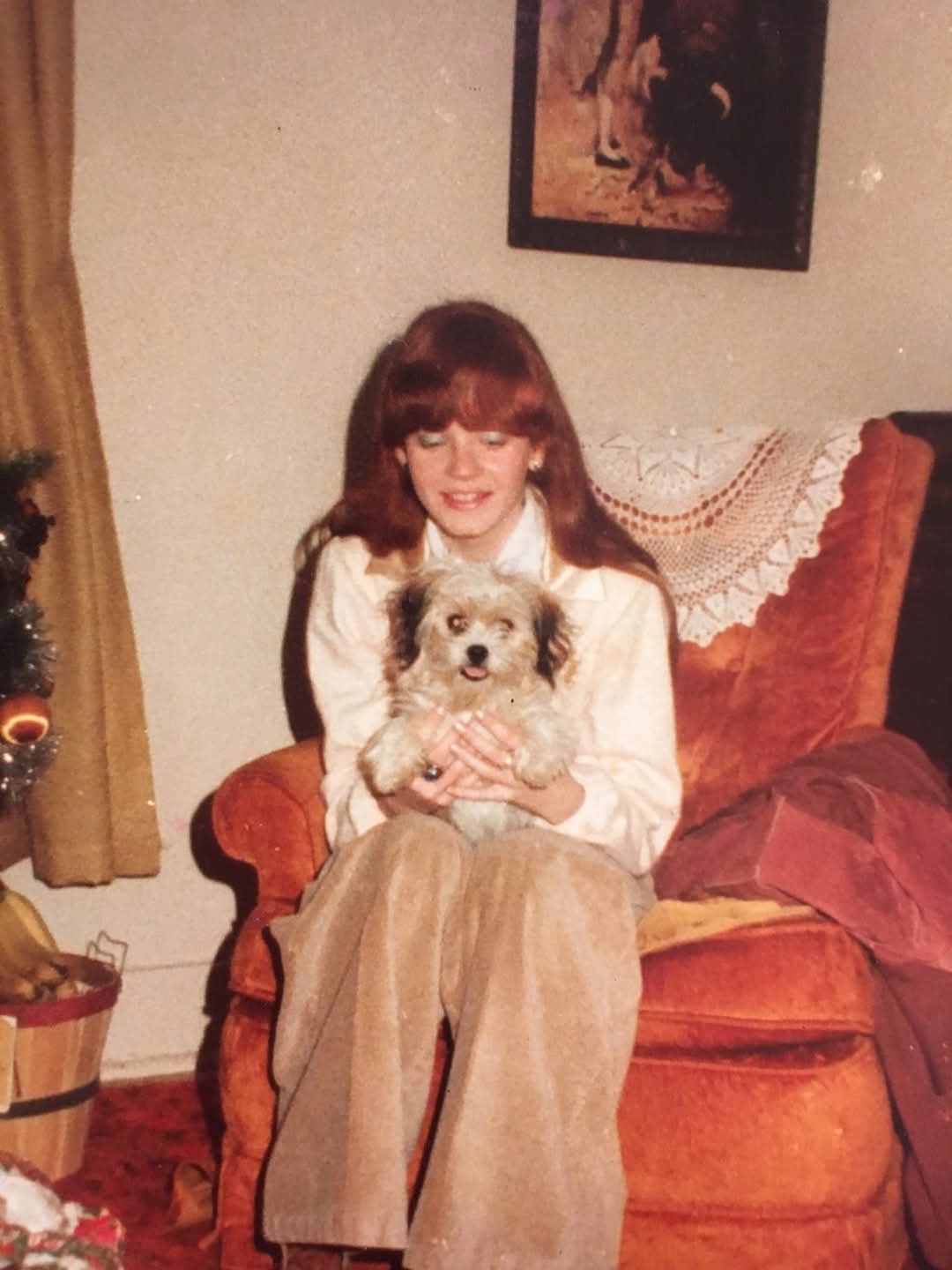 A photo of Cheryl Anne Scherer holding a dog.