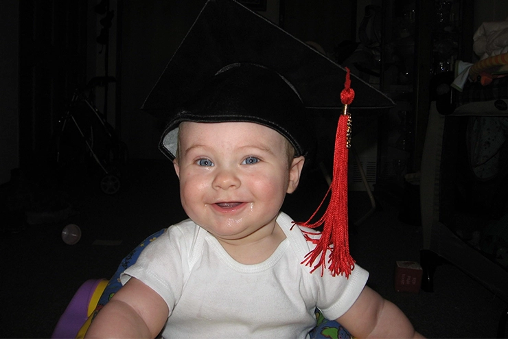 Ethan Griggs wearing his mother, Tara's, graduation cap and tassle.