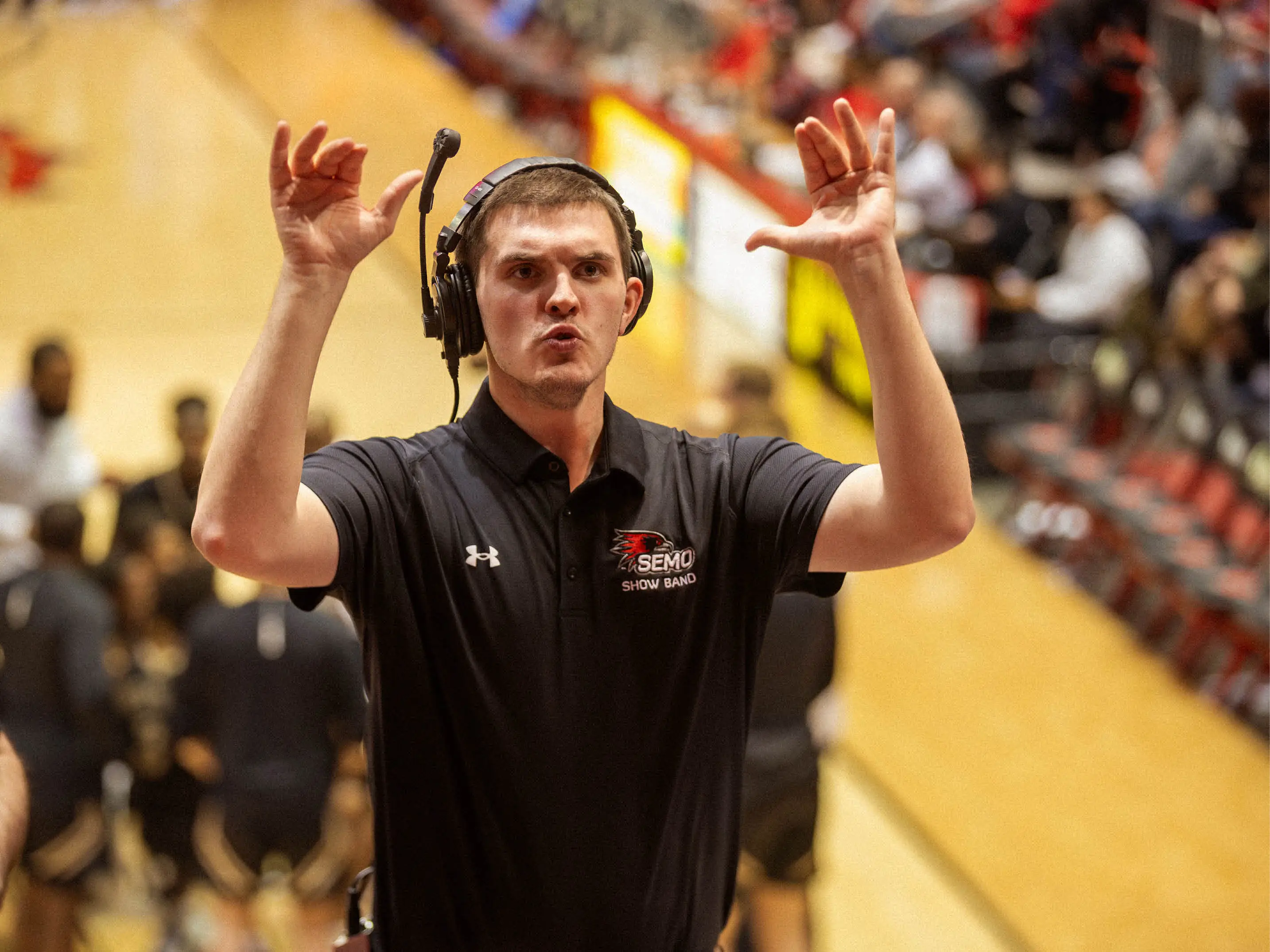 A photo of SEMO graduate, Isaac Thorn, directing the SEMO Band.