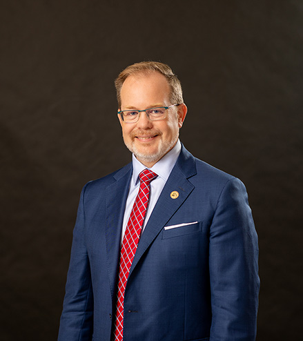 Professional portrait of Dr. Jason Lane, SEMO Alumni, against a black background.