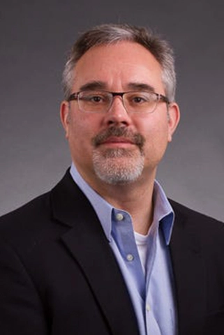 A professional headshot of Dr. Brian L. Ott.