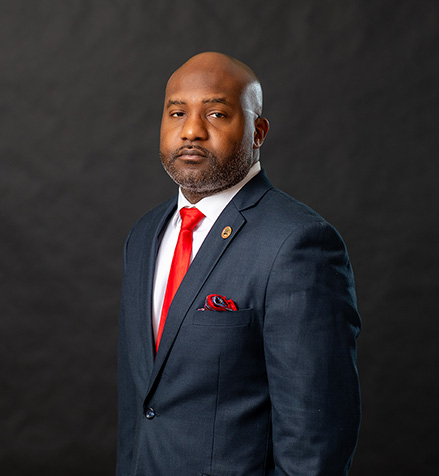 Professional portrait of Roosevelt Mitchell III, SEMO alumni against a black background.