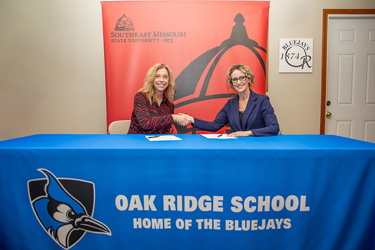 Dr. Debbie Below from SEMO shakes hands with Dr. Sonia Wood of Oak Ridge School District at a signing event.