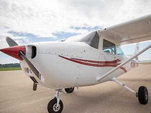 A small, red and white airplane.
