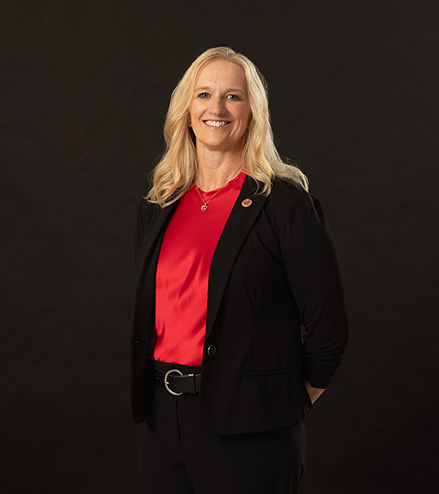 Professional portrait of Tiffany Rodriguez, SEMO alumni standing in front of a black background.