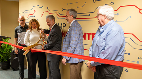 Ribbon cutting in front of the Charles Stamp Cyber Command Center at SEMO.