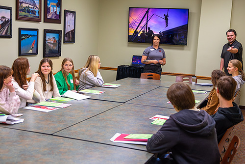 Group of Southeast Missouri State University students sitting around a table and discussing during a First STEP Orientation meeting.