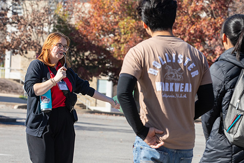 Southeast Missouri State University campus tour guide speaking and gesturing while leading a group of prospective students.