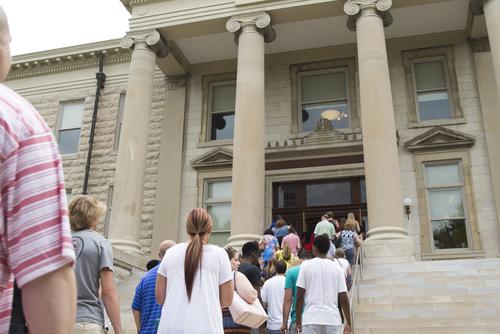 Students and parents walk up the stairs to Academic Hall.