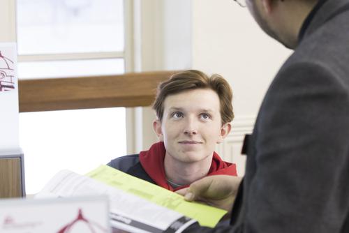 A student receives one on one support from an academic advisor when discussing a class schedule.