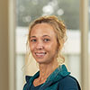 a professionally shot portrait of courtney kisat posed against a sunny, blurred out background