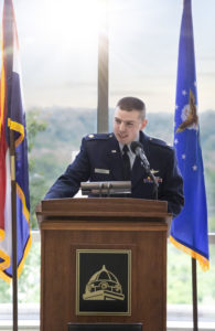 Major J. Bohnert speaking at a podium
