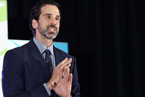 George standing on a stage in front of an audience