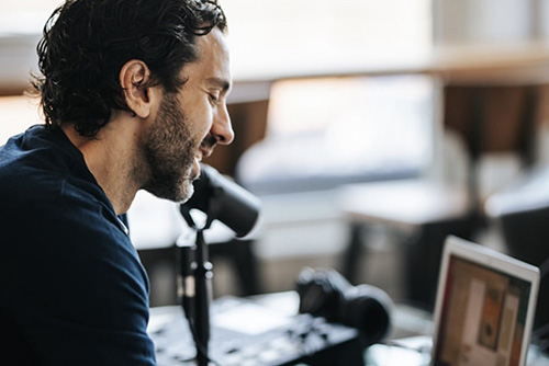 George working on his laptop.