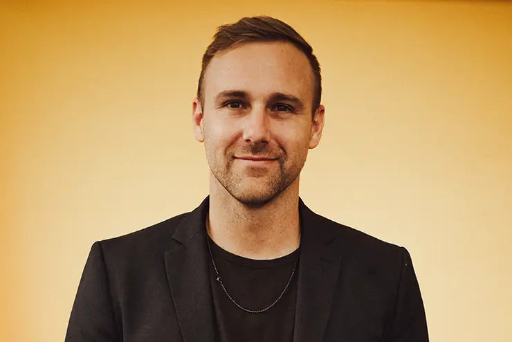 a professional portrait of Tyler Tarver smiling for the camera