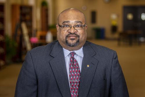 Dr. Victor Wilburn a child care degree professor stands for a portrait.