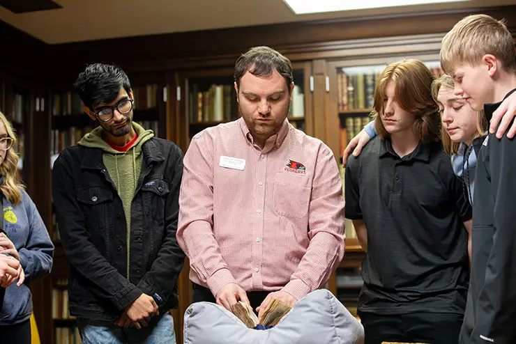 students at SEMO gather around and listen to a presentatin in Kent Library's rare book room.