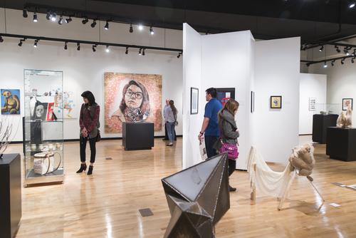 Guests enjoy the Juried Student Exhibition in Crisp Museum at River Campus 