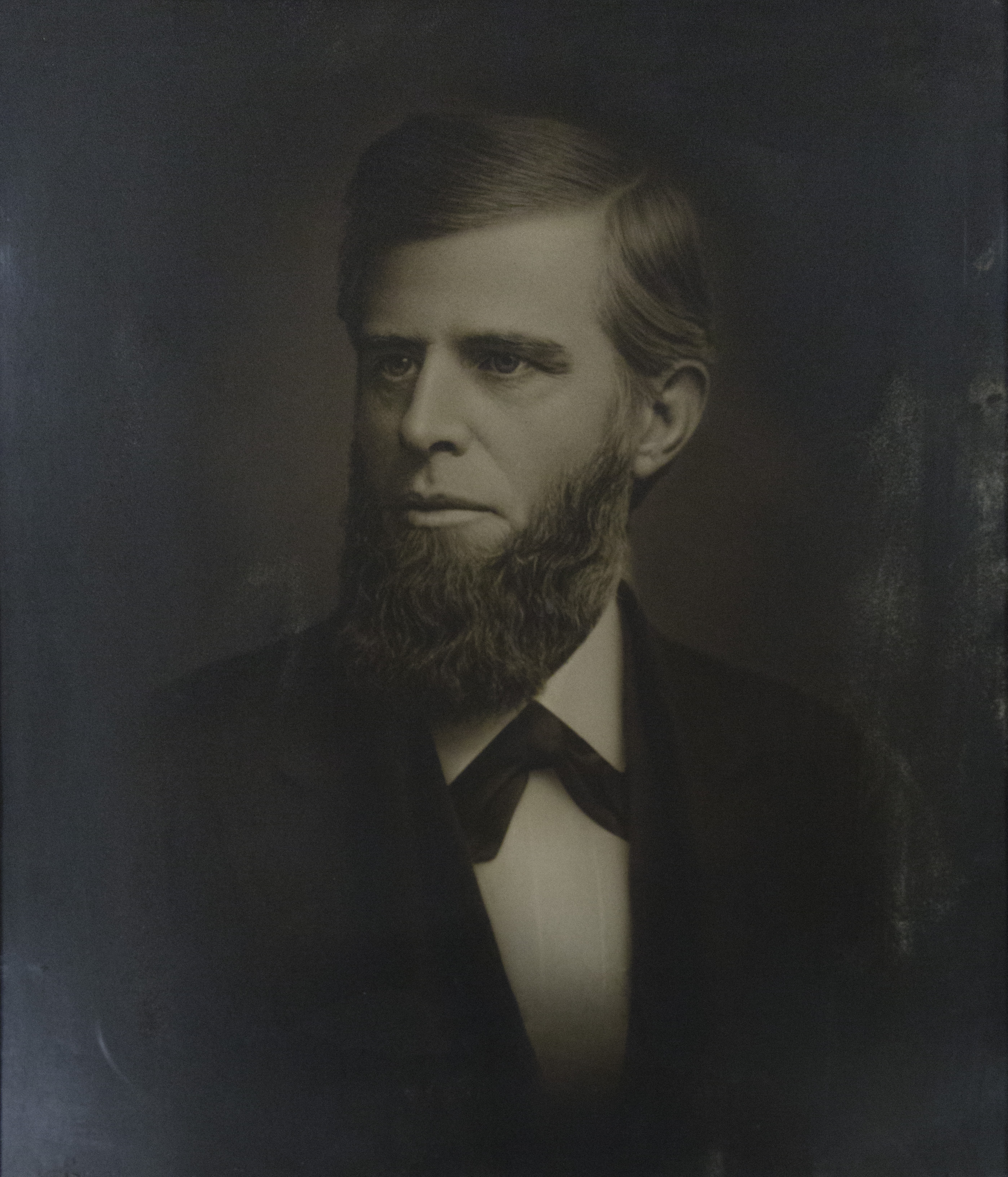 A headshot of Lucius H. Cheney. He looks sternly off to the left side. 