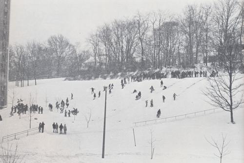 Students sledding down Cardiac Hill on a snowy day