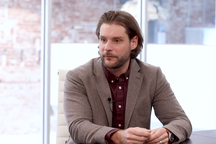 Steve Gipson talks while sitting at a conference table