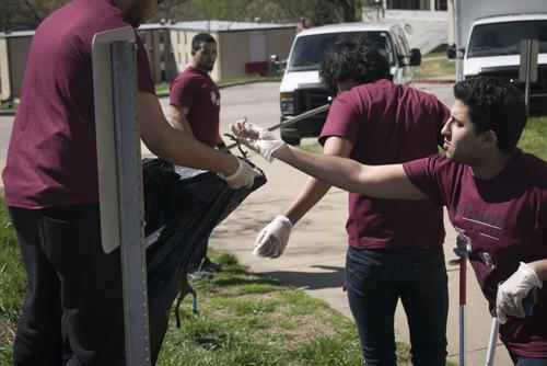 students picking up sticks 