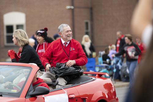 President in the parade smiling 