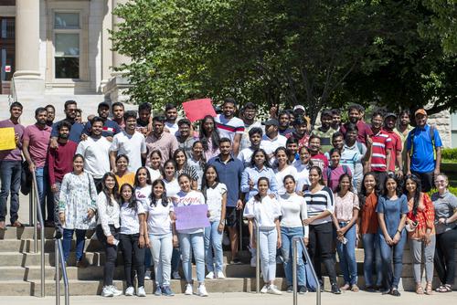 Group of international students all standing together and smiling