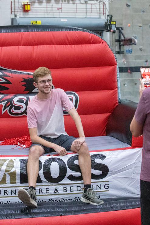 Student siting taking a picture on move-in day