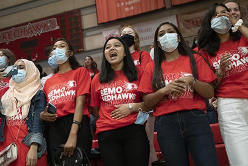 Students cheer at opening week while wearing matching t-shirts that read SEMO Redhawks.