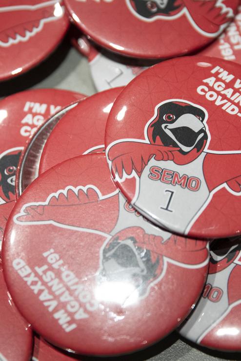 Buttons with Rowdy pointing on them that say "I'm vaxxed against Covid-19"