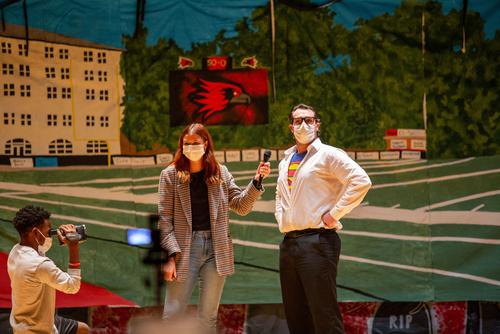 Two students sing on stage during the Greek Week singing competition