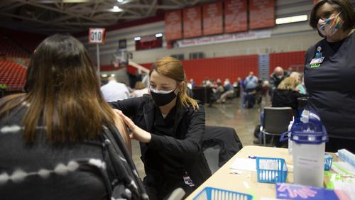 A women getting a vaccine injection at a clinic