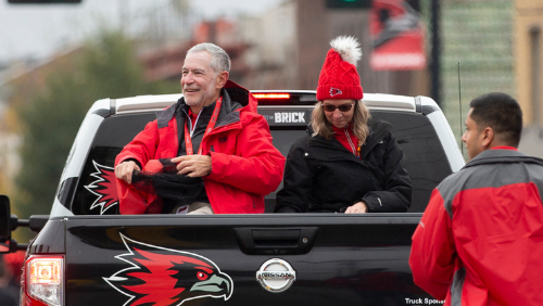 Southeast President Dr. Carlos Vargas and Pam Vargas wave to parade goers.