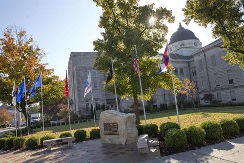 Veterans Plaza outside of Academic Hall. It is a big rock with all the military flags