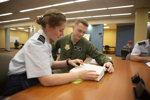 SEMO ROTC students reading a book in the library