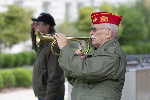 Veteran playing the trumpet at the gathering of remembrance at the Veterans Plaza