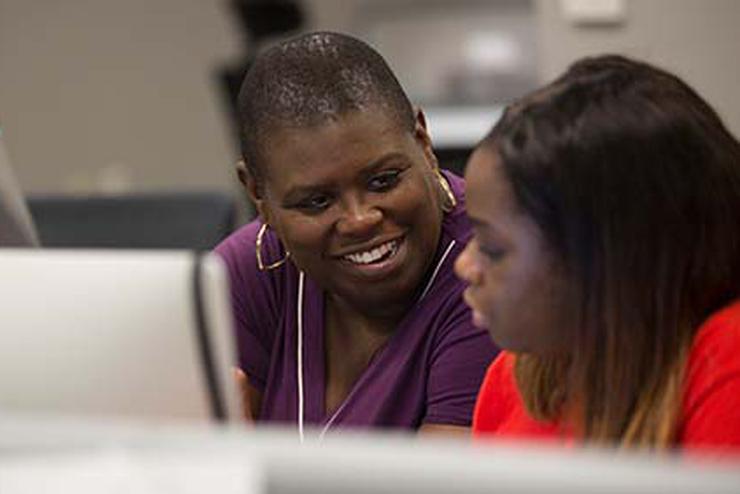 Dr. Tamara Buck works with a student in the Arrow offices