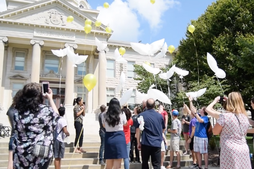People release balloons in front of Academic Hall