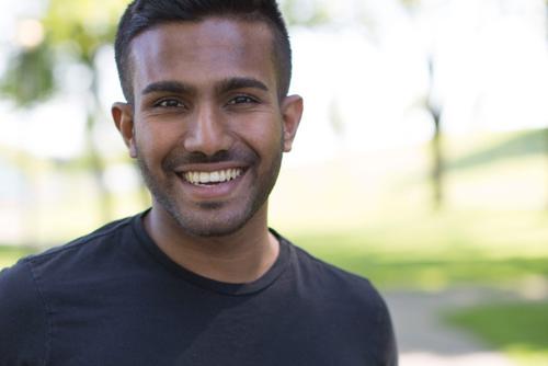 Sindupa de Silva smiles into the camera