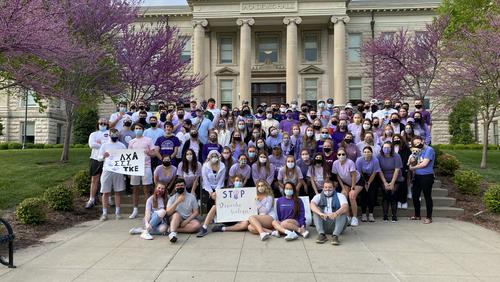 Heather Hoffman and a group of Fraternity and Sorority Life students poste in front of Academic Hall
