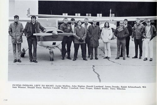 A group of students interested in aviation smile at the airport.