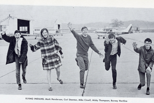 Students pretend to run for the camera in a black and white photo.