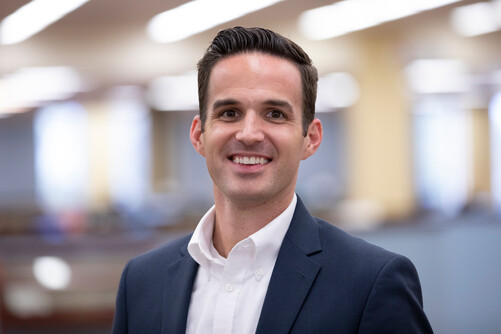 Dan Presson smiles for a photo in professional attire.