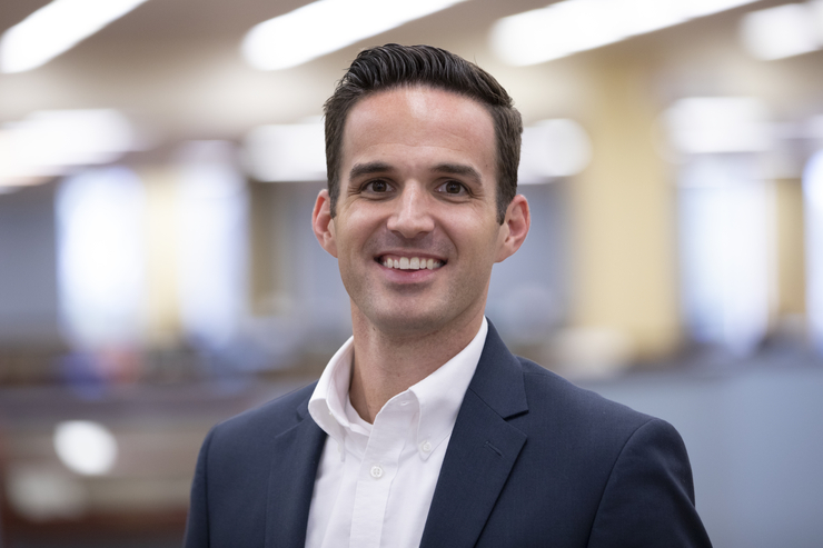 Dan Presson smiles for a photo in professional attire.