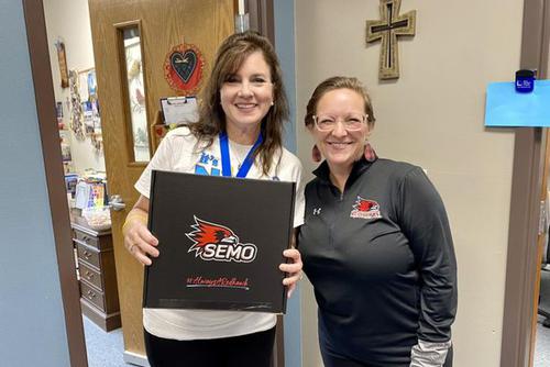 Lenell Hahn presents a teacher with a thank you gift